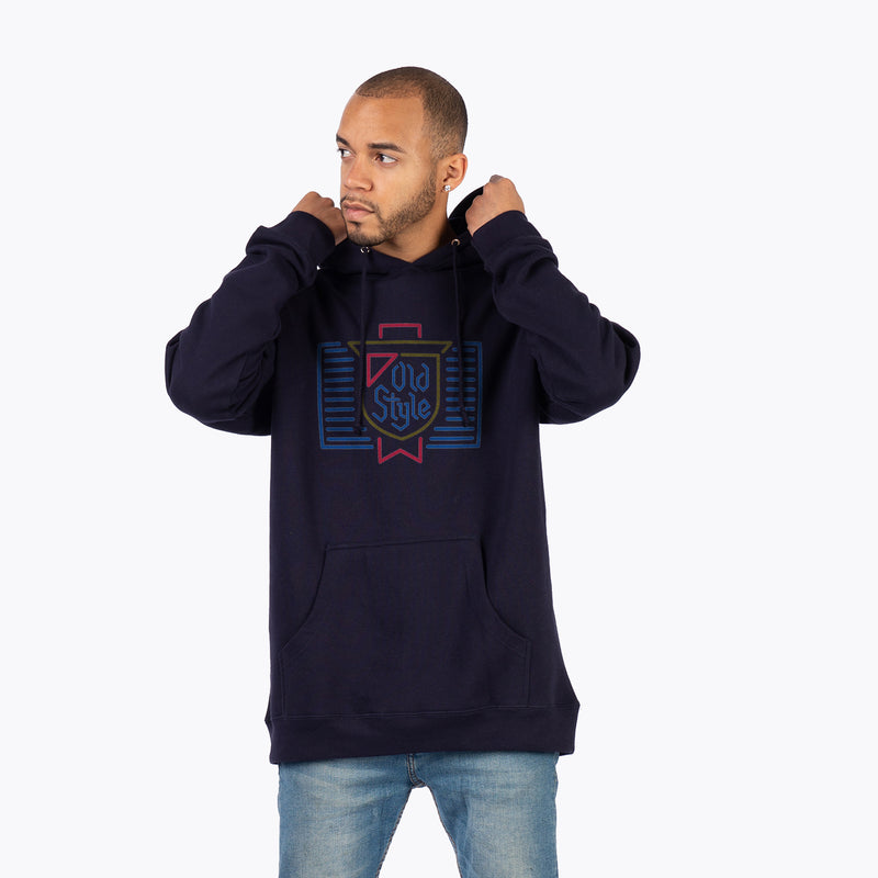front of man wearing hoodie with neon sign of old style logo design 